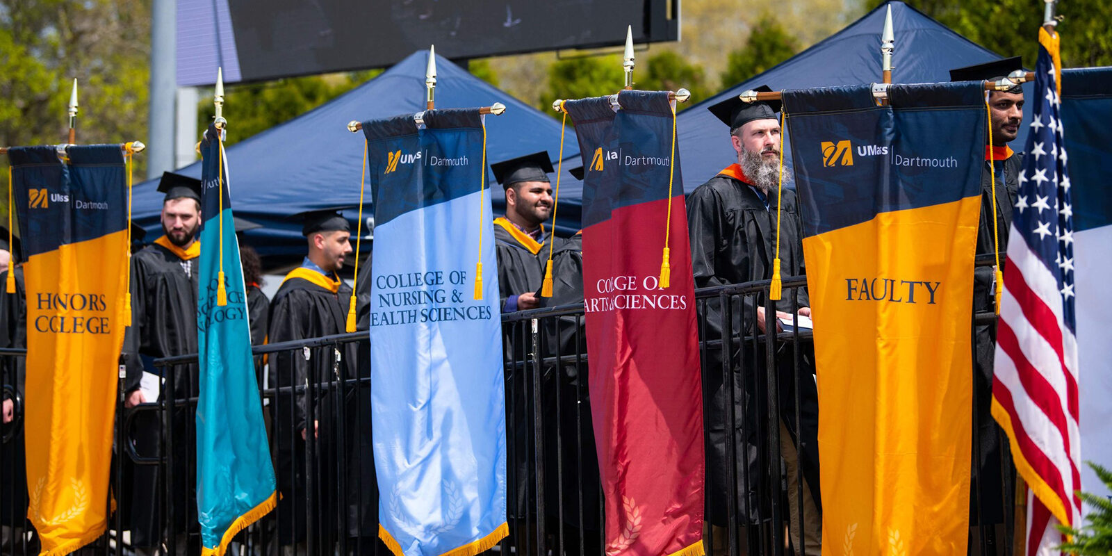 UMass Dartmouth graduation procession banners.