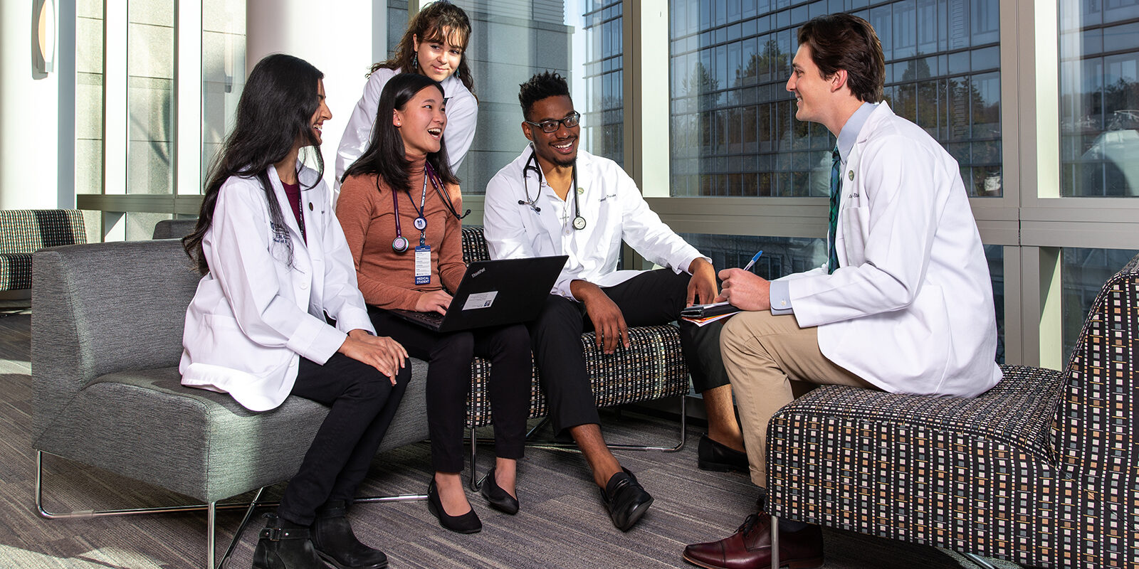 UMass Students in white lab coats.