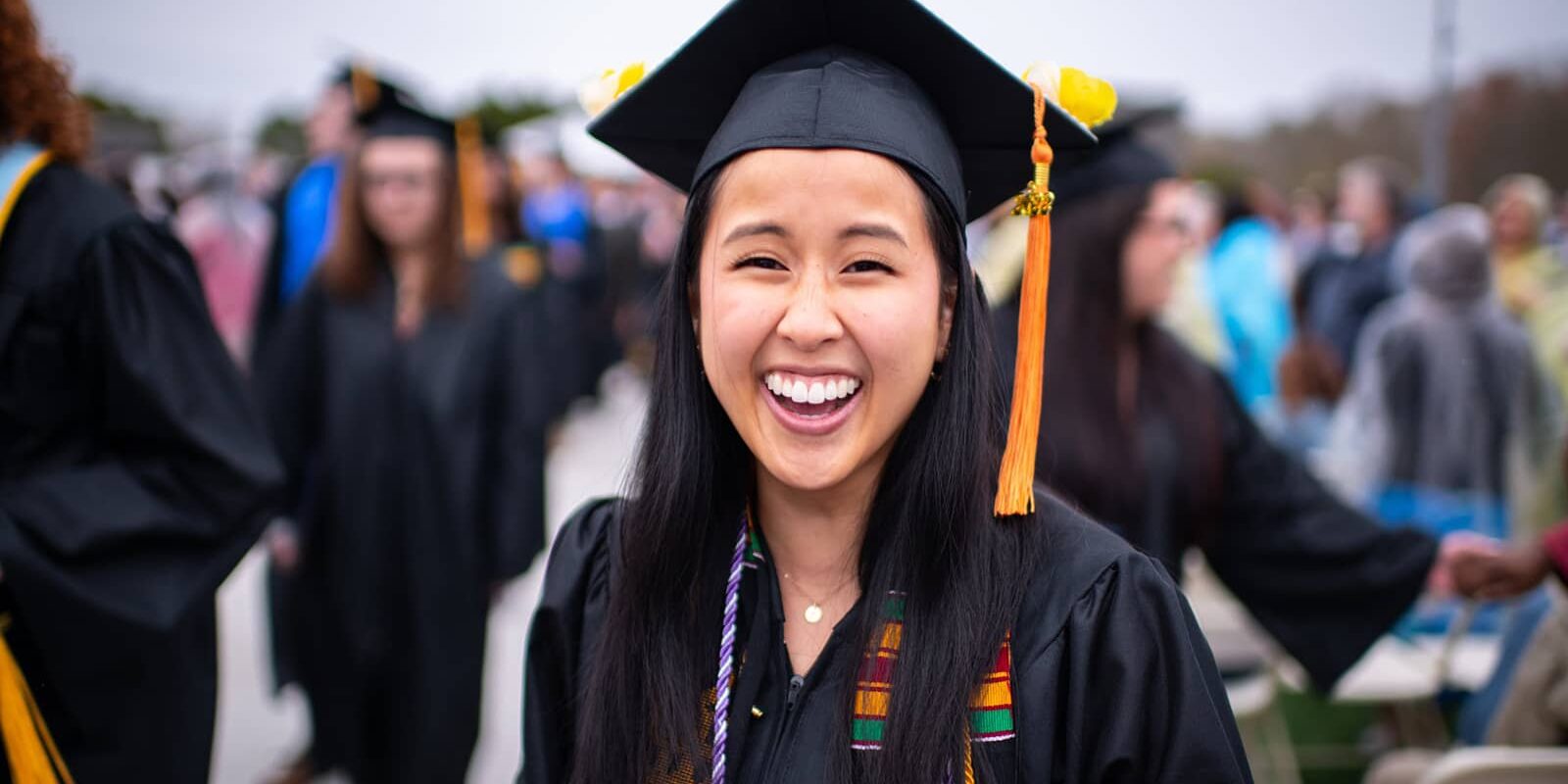 Smiling female UMass graduate.